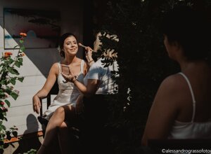 Bride getting makeup done outdoors, preparing for a Sicilian destination wedding
