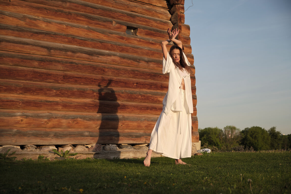 woman-white-attire-dances-gracefully-wooden-building-sunset-this-image-reflects-beauty-movement-harmony-nature-human-expression.jpeg