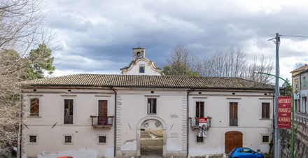 Facciata di un edificio storico con ingresso ad arco e museo dei fossili.