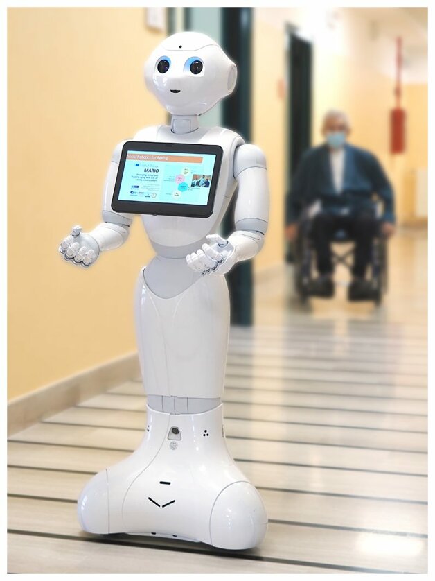 Humanoid robot with a tablet screen in a corridor, promoting AI solutions and cognitive rehabilitation