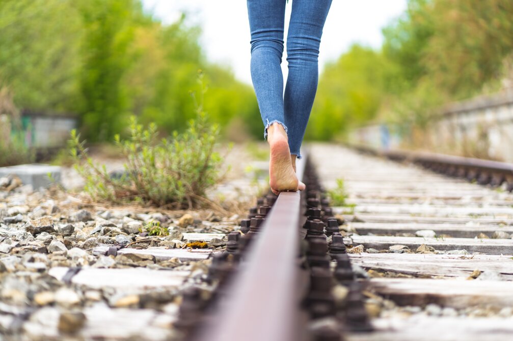 female-jeans-walking-through-train-rails-barefoot(1).jpeg