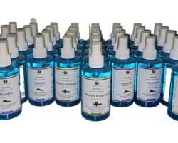 Bottiglie di acque aromatiche naturali a base di issopo, menta piperita e lavanda per il benessere.