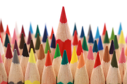 Lapices de colores agrupados en el que resalta es el color rojo