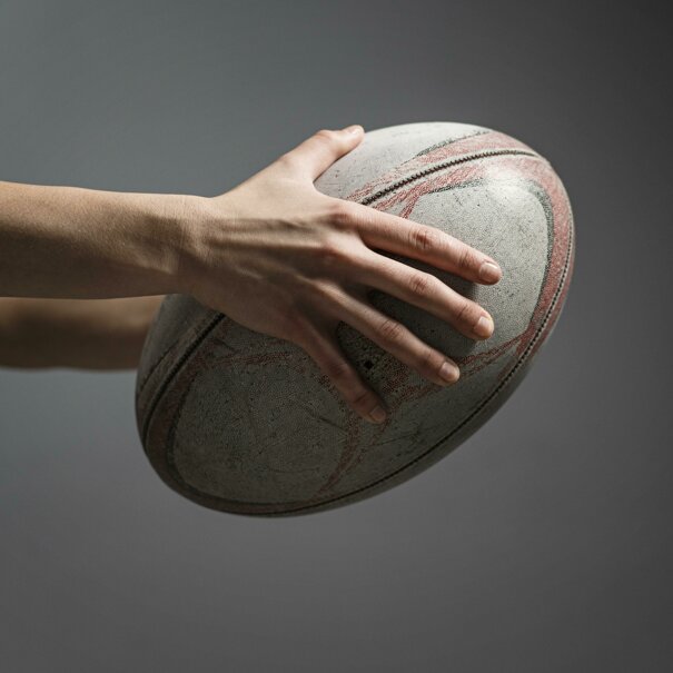 side-view-female-rugby-player-s-hand-holding-ball