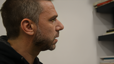 Man in profile looking at shelves with books