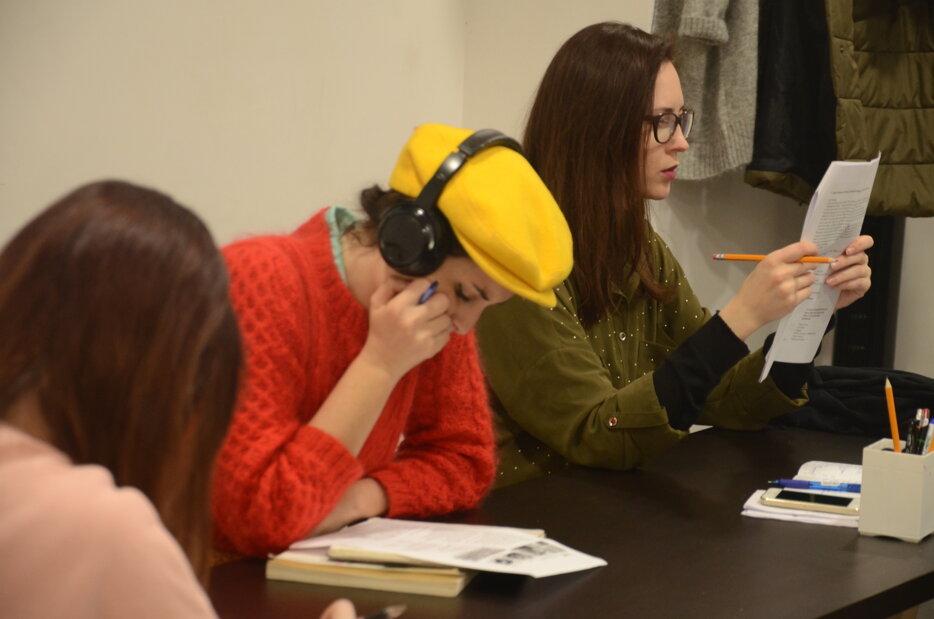 Students focusing on Italian language exam preparation in classroom Students focusing on Italian language exam preparation in classroom