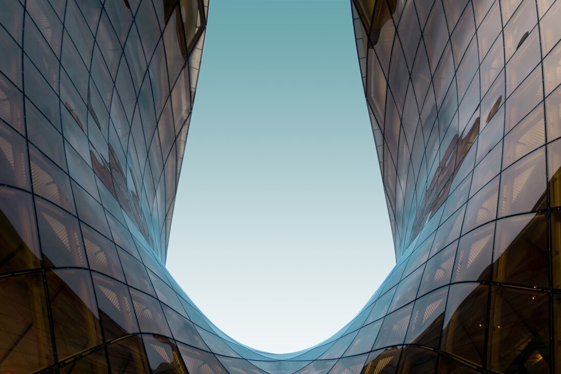 glass-u-shaped-structure-with-blue-sky.jpeg