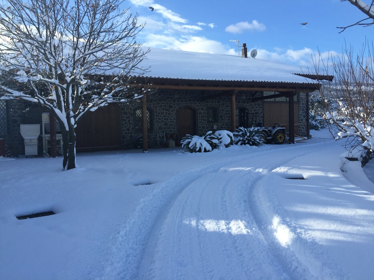 Traditional family-run winery covered in snow at the base of Etna, showcasing volcanic terroir.
