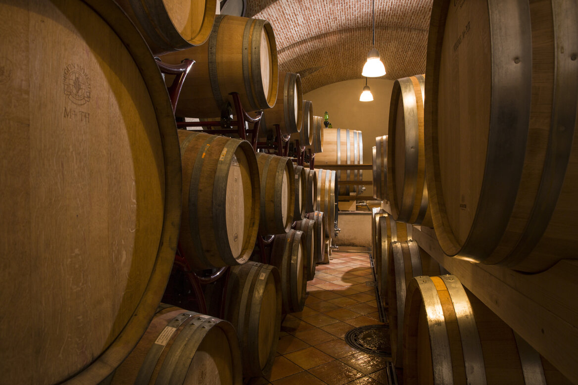 Barrels in a traditional family-run winery on Etna showcasing innovation and volcanic terroir.