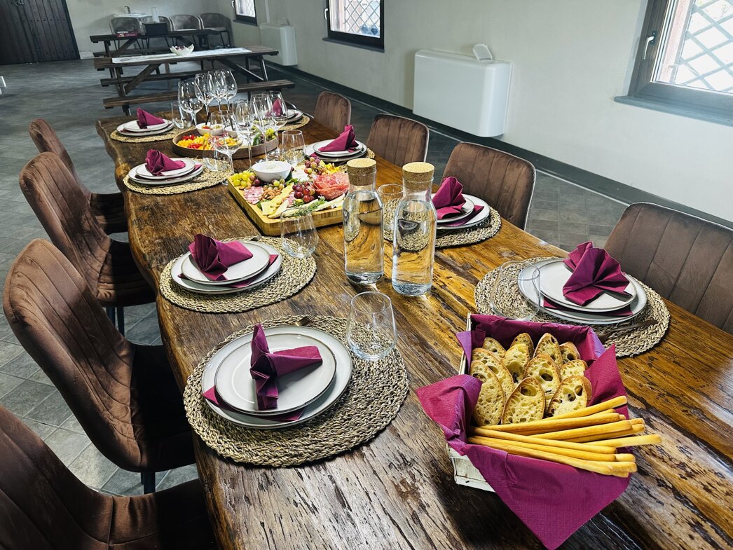 Elegant table setting with appetizers and breadsticks on a wooden table.