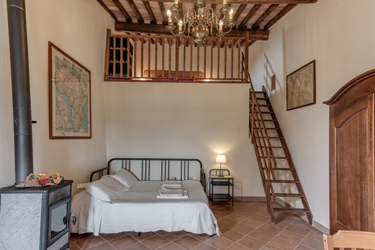 Comfortable double bedroom and twin sofa bed with private bathroom and kitchen for large group accommodation in Tuscany