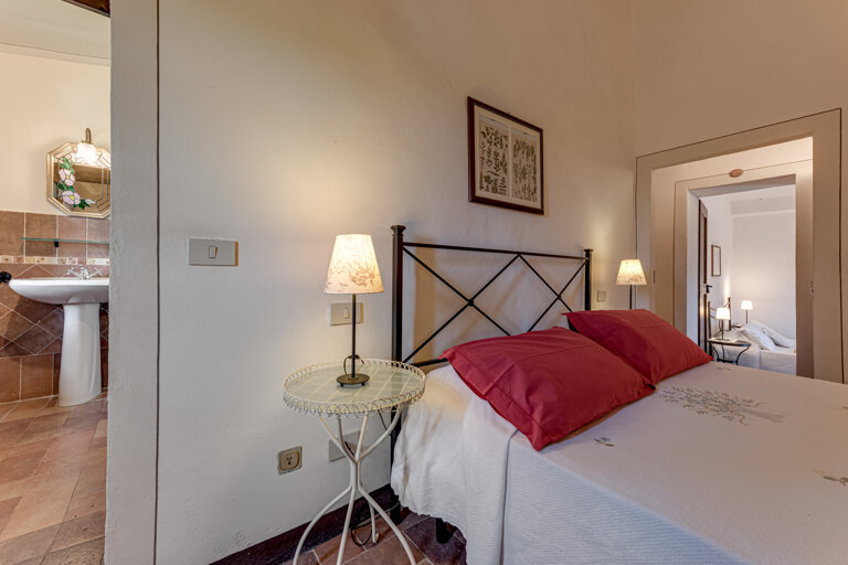 Comfortable double bedroom with private en-suite bathroom at the group rental villa