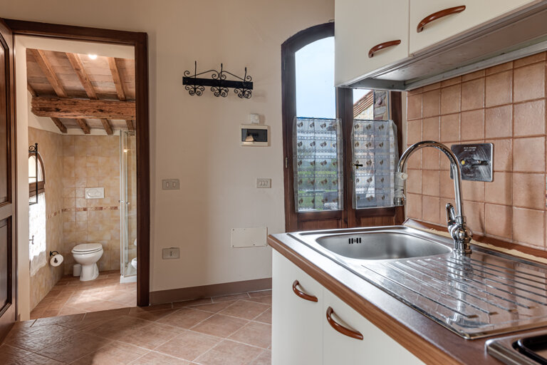 Comfortable double bedroom and twin sofa bed with private bathroom and kitchen for large group accommodation in Tuscany