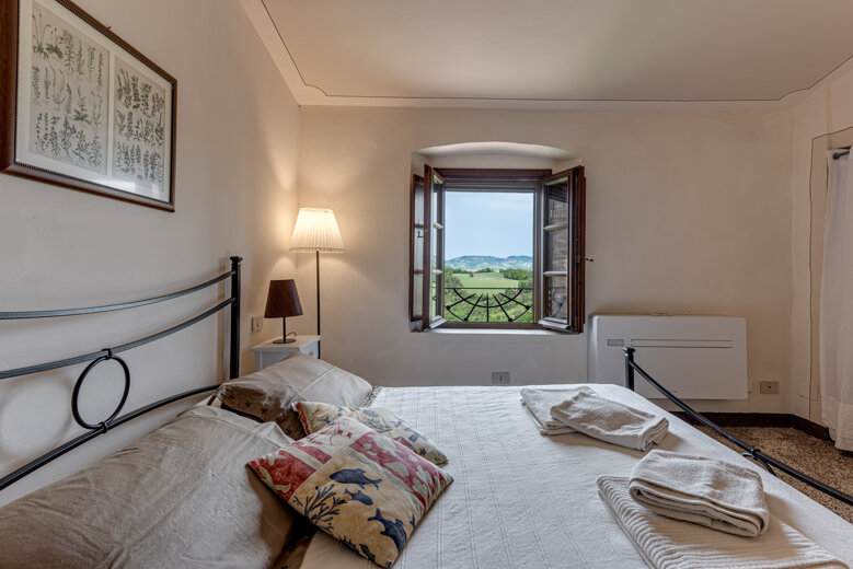 Comfortable double bedroom with private en-suite bathroom at the group rental villa