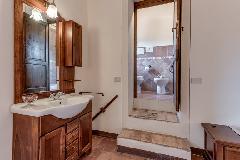 Comfortable double bedroom with private en-suite bathroom at the group rental villa