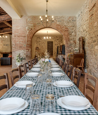 Spacious stone wall living room for large groups inside exclusive Tuscan farmhouse