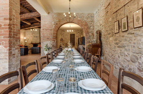 Spacious stone wall living room for large groups inside exclusive Tuscan farmhouse