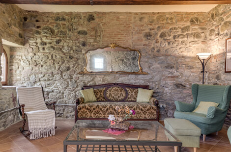 Spacious stone wall living room for large groups inside exclusive Tuscan farmhouse