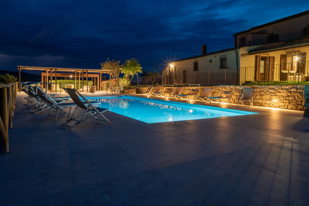 Private swimming pool at night for luxury evening gatherings at the Tuscan villa