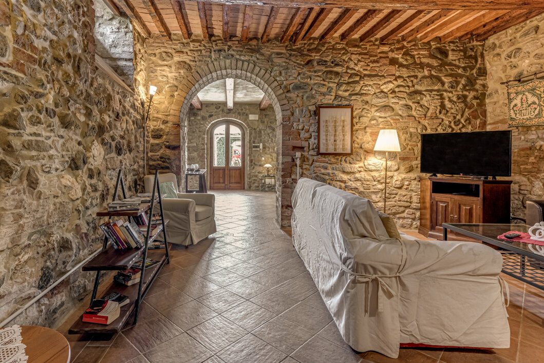 Spacious stone wall living room for large groups inside exclusive Tuscan farmhouse