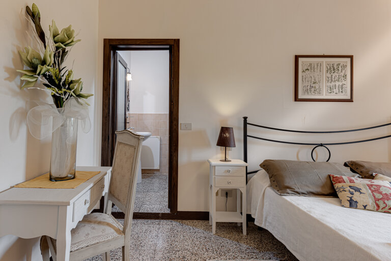 Comfortable double bedroom with private en-suite bathroom at the group rental villa