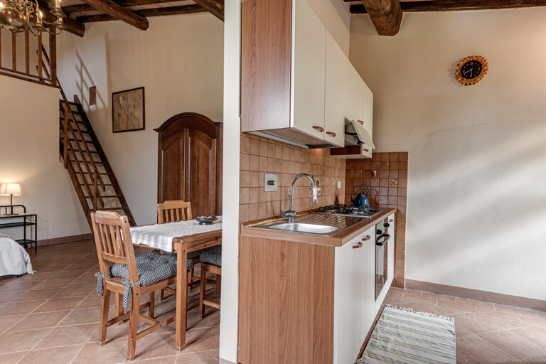 Comfortable double bedroom and twin sofa bed with private bathroom and kitchen for large group accommodation in Tuscany