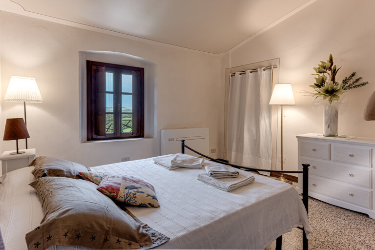 Comfortable double bedroom with private en-suite bathroom at the group rental villa