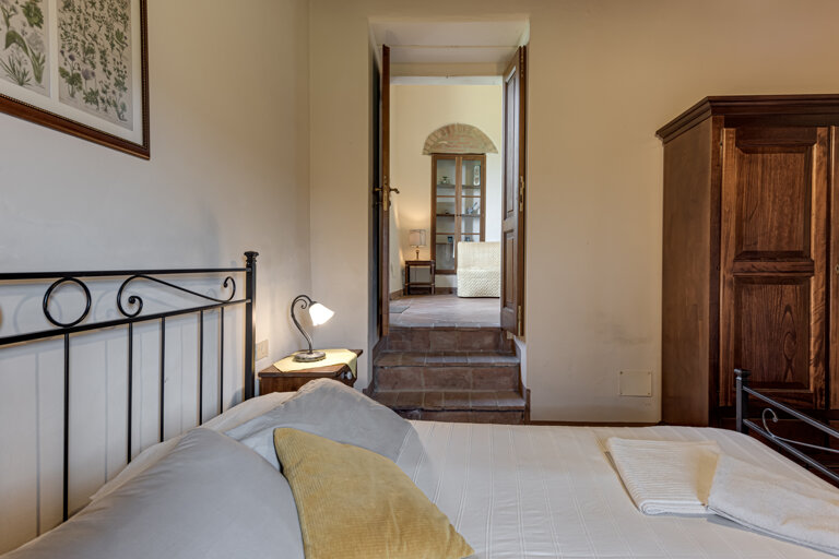 Comfortable double bedroom with private bathroom for large group accommodation in Tuscany
