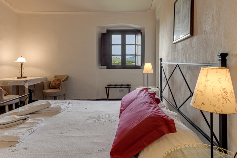 Comfortable double bedroom with private en-suite bathroom at the group rental villa