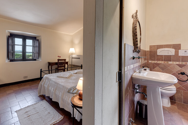 Comfortable double bedroom with private bathroom for large group accommodation in Volterra villa