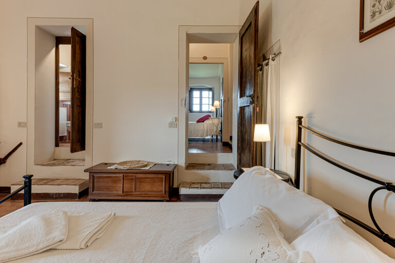 Comfortable double bedroom with private en-suite bathroom at the group rental villa