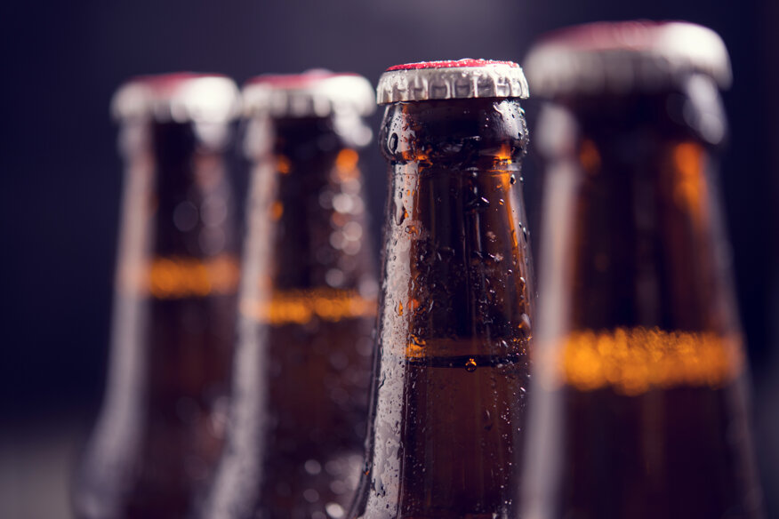 close-up-glass-bottles-beer-with-ice-dark-background.jpeg