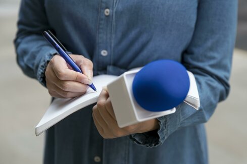 close-up-interviewee-taking-notes.jpeg