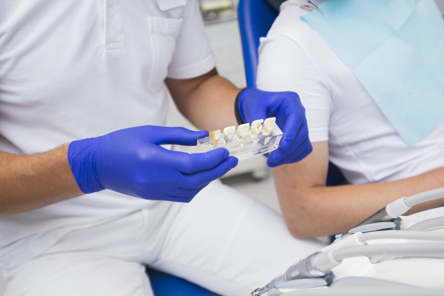 dentist-holding-variety-teeth.jpeg