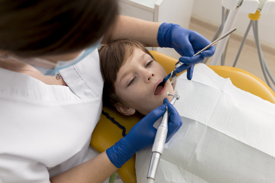 dentist-cleaning-child-s-teeth.jpeg