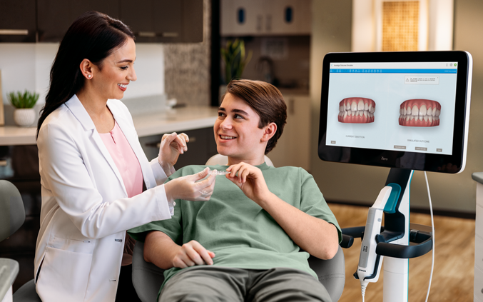 photo-resources-hero-female-doctor-and-boy-patient-holding-aligners