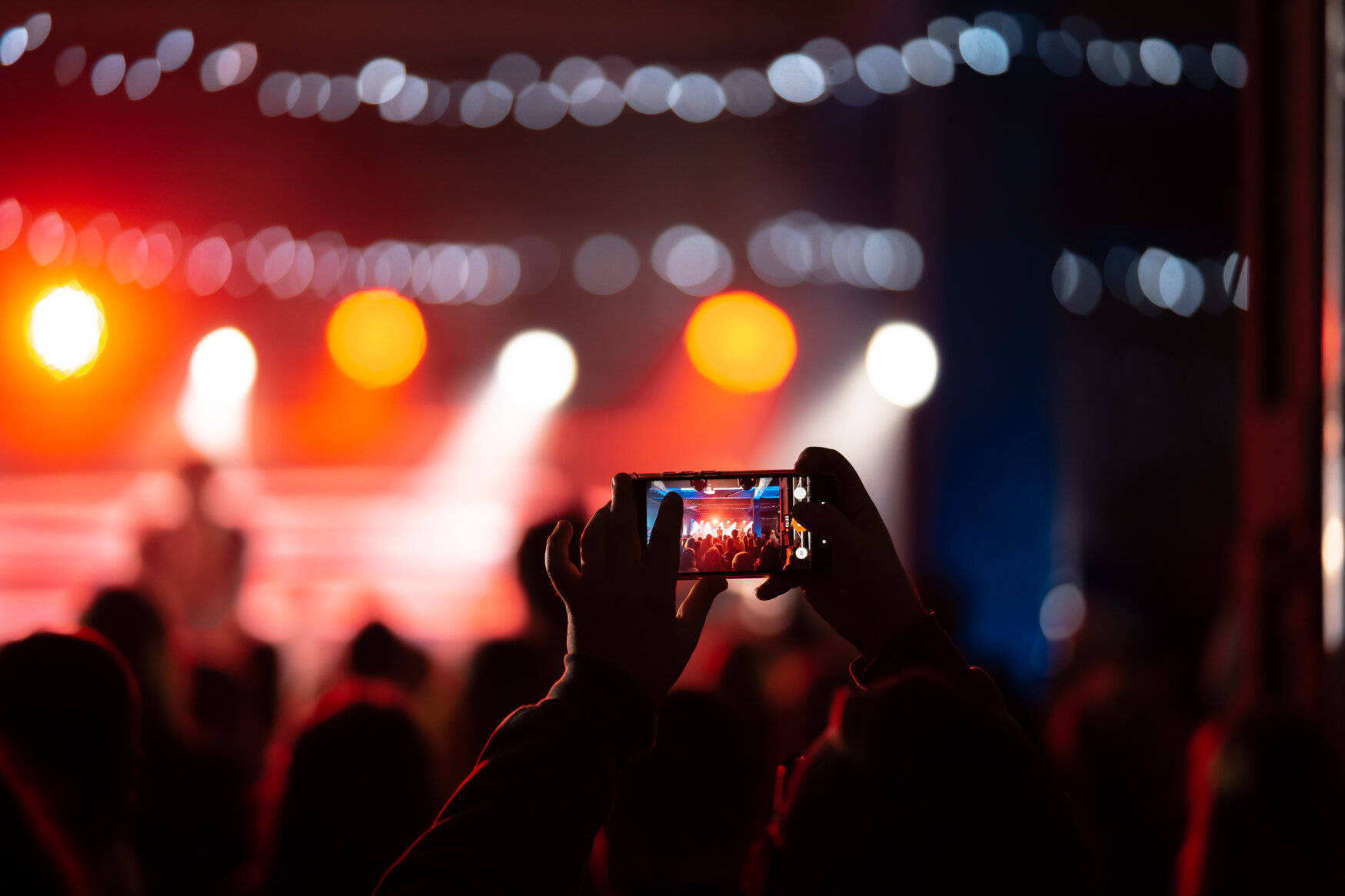close-up-recording-video-with-smartphone-concert-toned-picture.jpeg