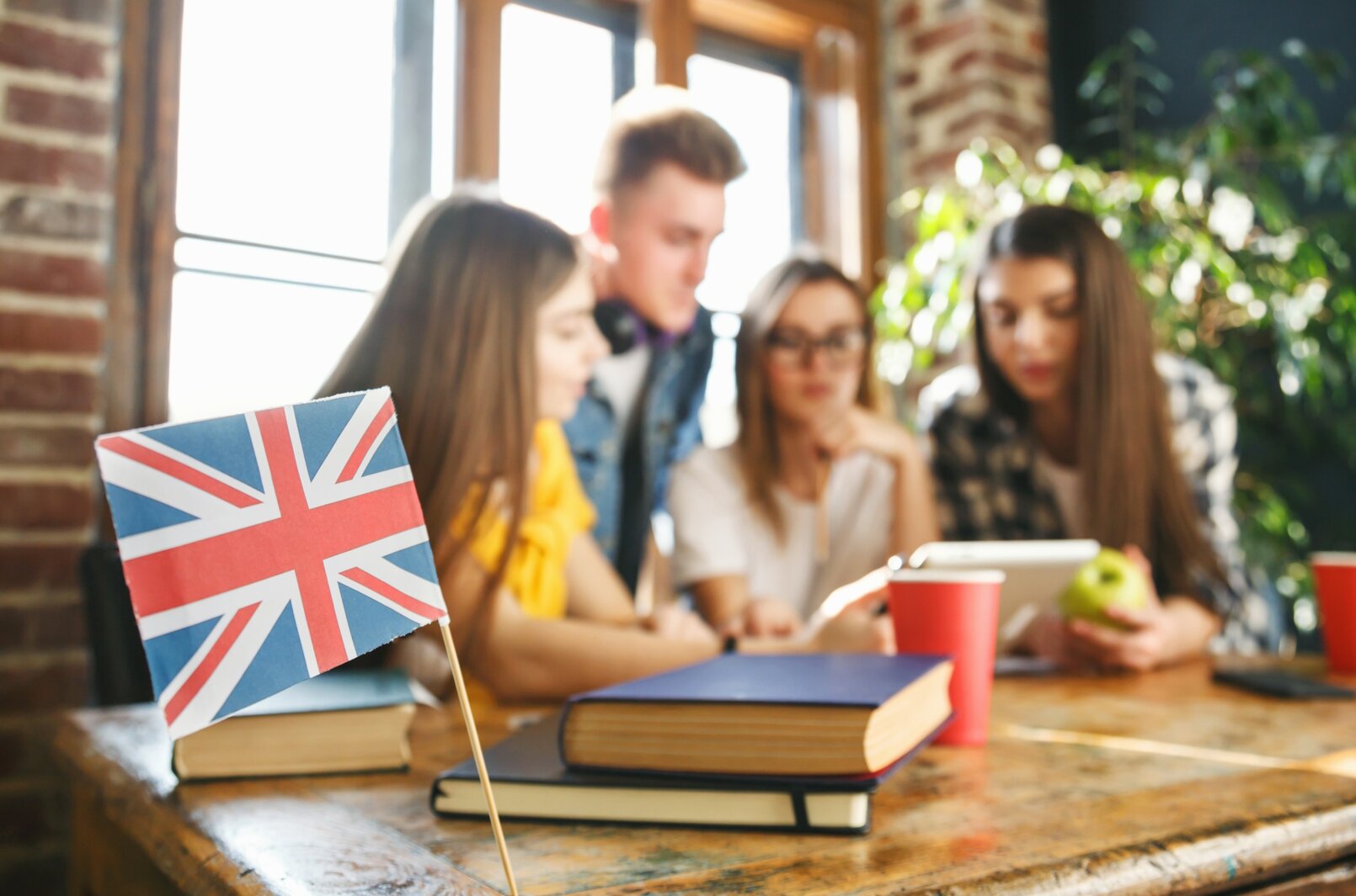 group-classmates-sitting-desk-looking-tablet-discussing-something-camera-focused-british-flag.jpeg group-classmates-sitting-desk-looking-tablet-discussing-something-camera-focused-british-flag.jpeg