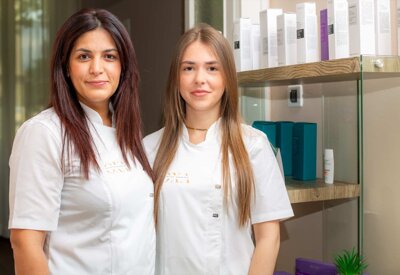 Elena Hoxha e assistente davanti a prodotti di bellezza
