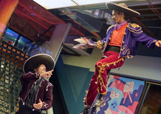 Dancers in traditional Mexican costumes performing during a live show