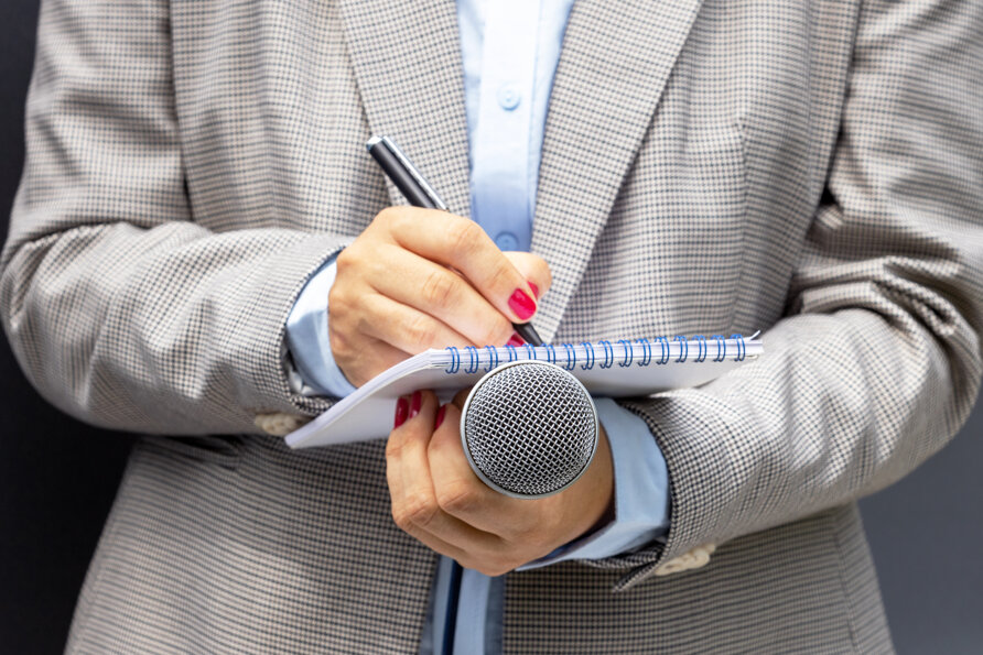 midsection-woman-writing-diary-while-holding-mic.jpeg
