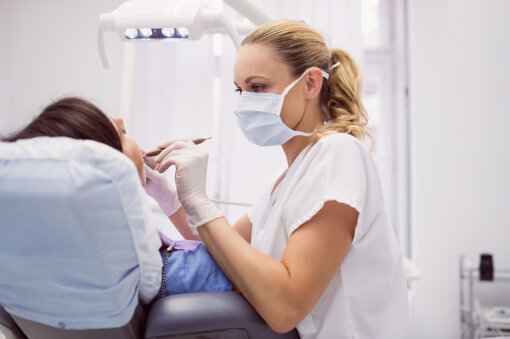 dentist-examining-female-patient.jpeg