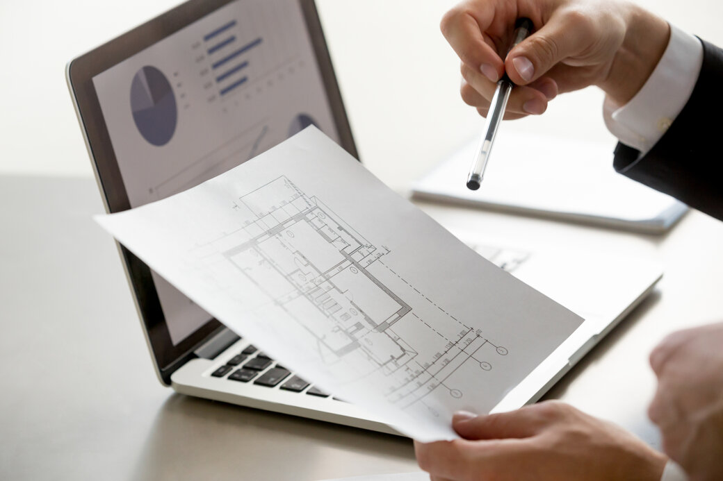 male-hand-holding-project-plan-statistics-screen-close-up.jpeg