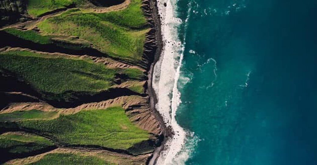 Green coastal landscape meeting the ocean Green coastal landscape meeting the ocean